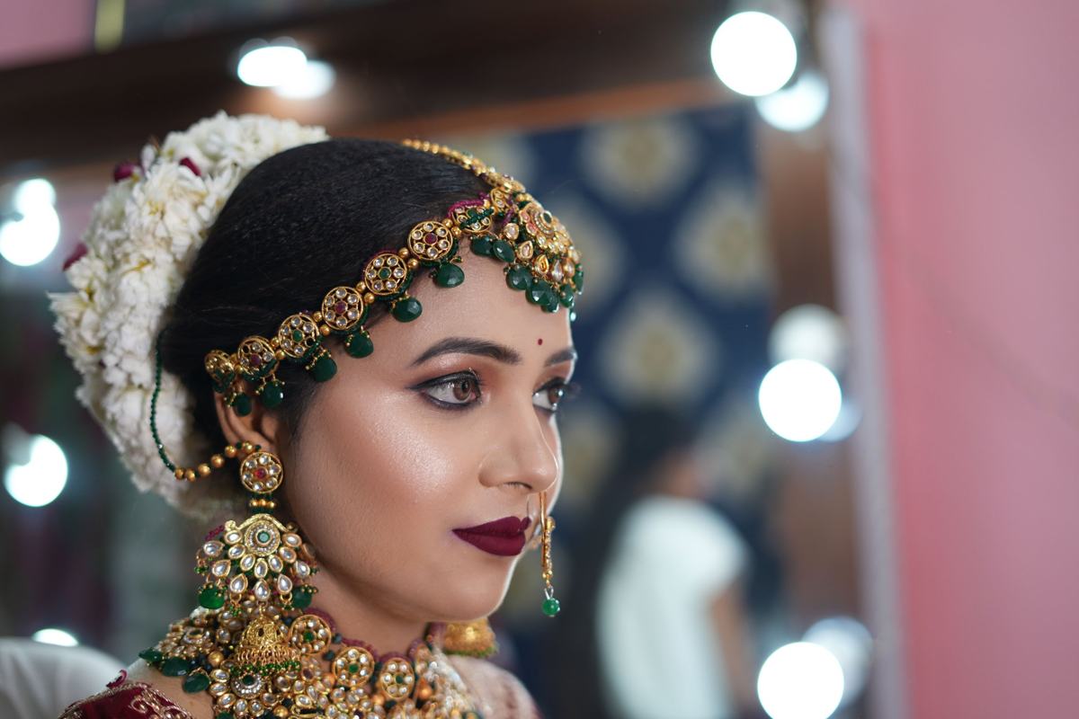 Illustrative image: bridal makeup with green and gold jewellery