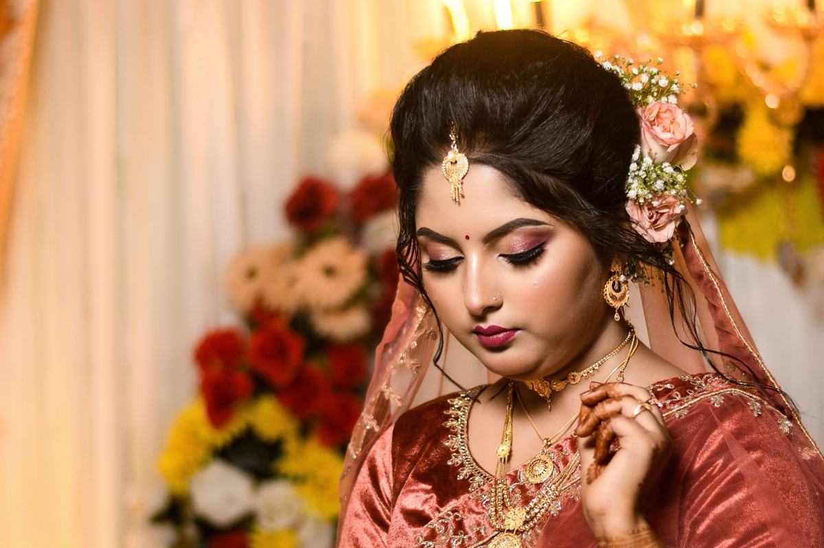 Illustrative image: bride with floral hair accessories and gold jewellery