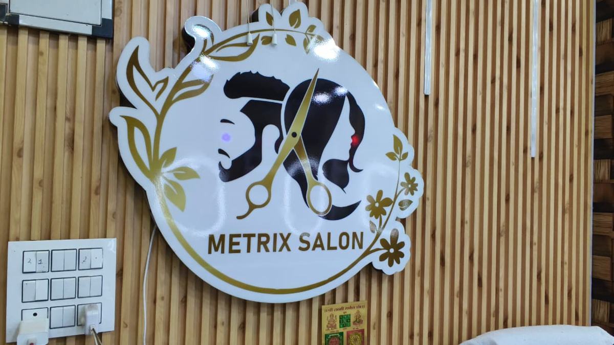 Metrix Beauty Studio: Metrix Salon logo sign on the studio wall
